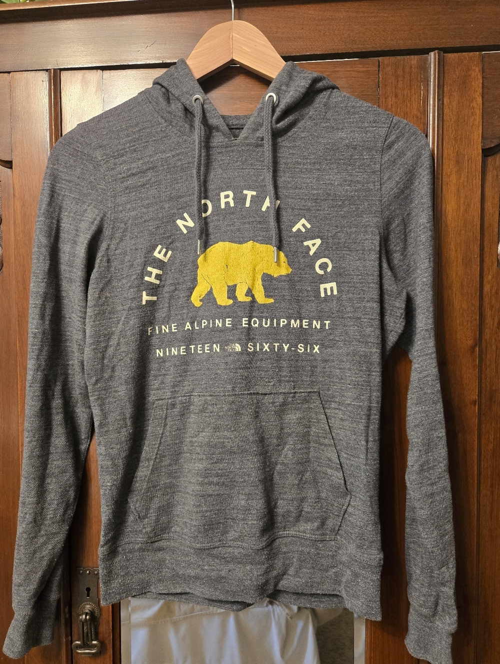 The North Face Gray Pullover Hoodie with Yellow Bear Graphic